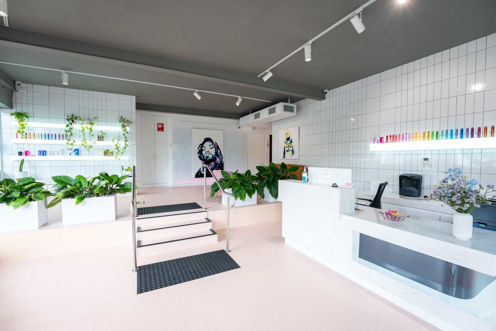 The entry to the practice, stairs with a handrail leading up past retail shelving to the front desk