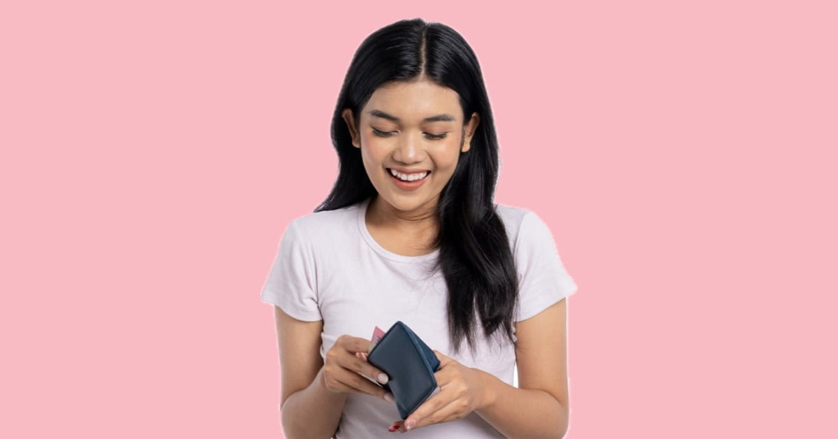 Woman looking into wallet, thinking about the long term ROI of dental care.